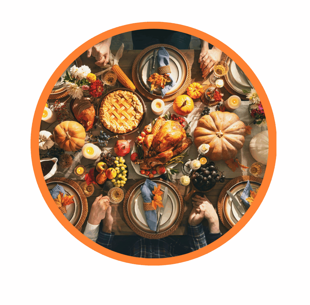family gathered around table full of thanksgiving food on thanksgiving day