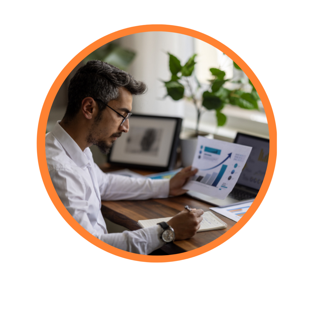 business owner sits at desk reviewing invoices and business cash flow